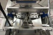 Newtec PCS2009 weigher with Ilapak Carrera 500 flowpack machine for trays