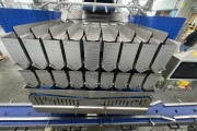 Newtec PCS2009 weigher with Ilapak Carrera 500 flowpack machine for trays